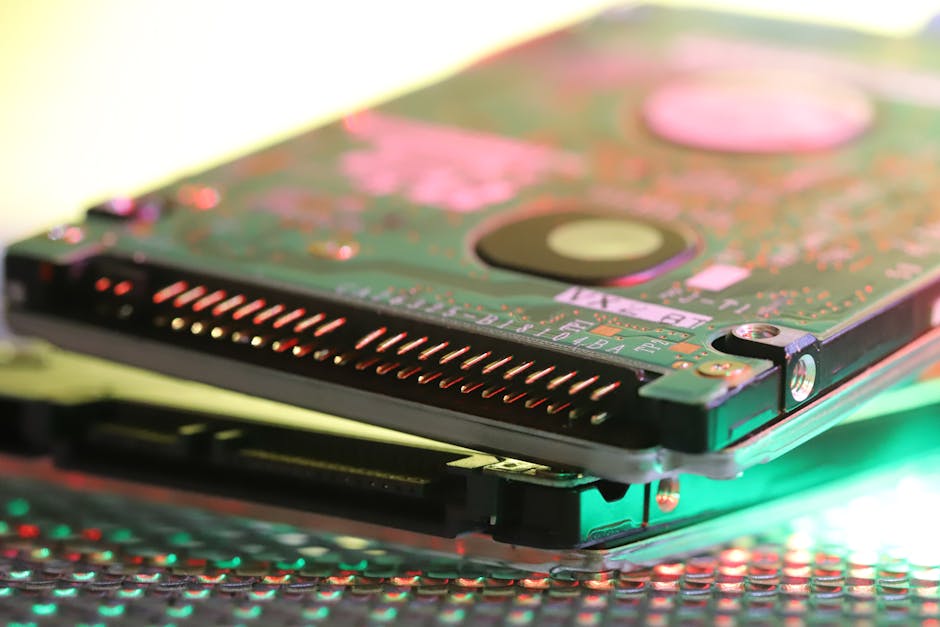 Detailed view of a computer hard disk circuit board with colorful reflections.